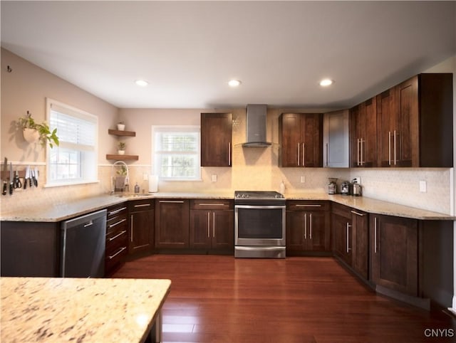 2480 Middle Rd, Oneida, NY 13421 - kitchen featuring stainless steel appliances, wall chimney exhaust hood, decorative backsplash, dark wood-style flooring, and light stone countertops