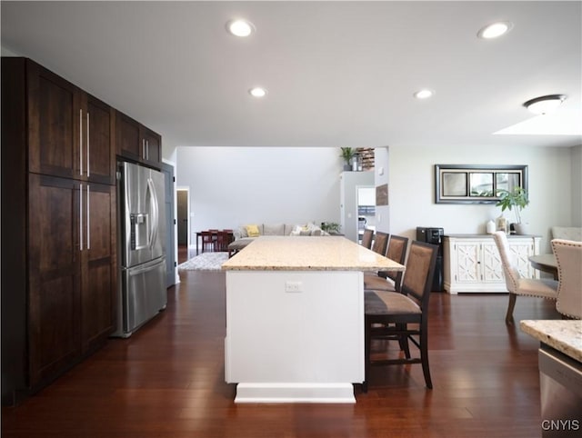2480 Middle Rd, Oneida, NY 13421 - kitchen with appliances with stainless steel finishes, open floor plan, a kitchen island, a kitchen breakfast bar, and dark brown cabinetry