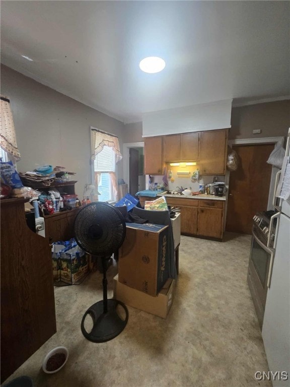 223 Lakeview Ave, Syracuse, NY 13204 - kitchen featuring brown cabinets, light colored carpet, and light countertops