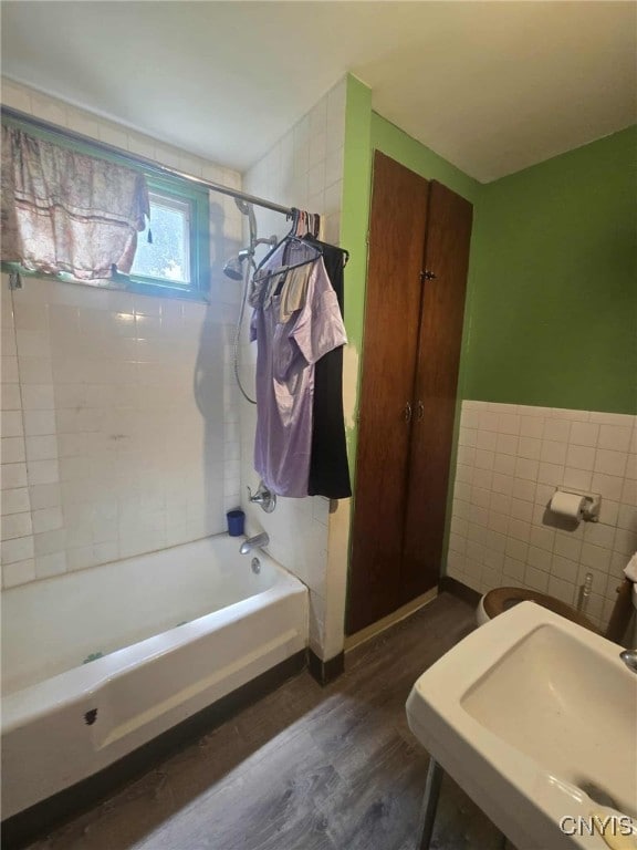 223 Lakeview Ave, Syracuse, NY 13204 - full bathroom with wood finished floors, shower / bathtub combination, and tile walls