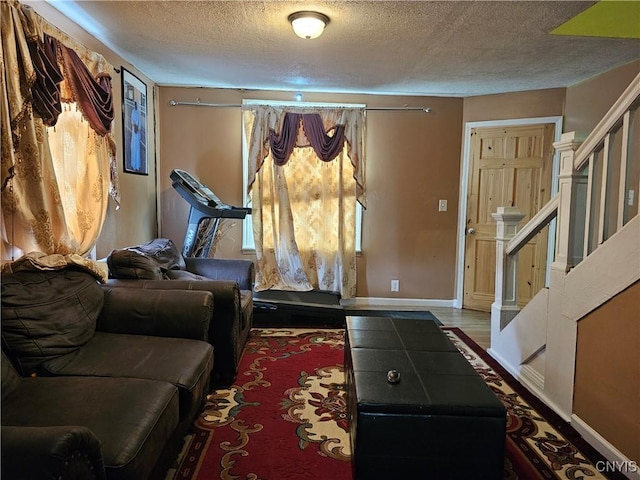 1125 Adams St, Utica, NY 13501 - exercise room with a textured ceiling and baseboards