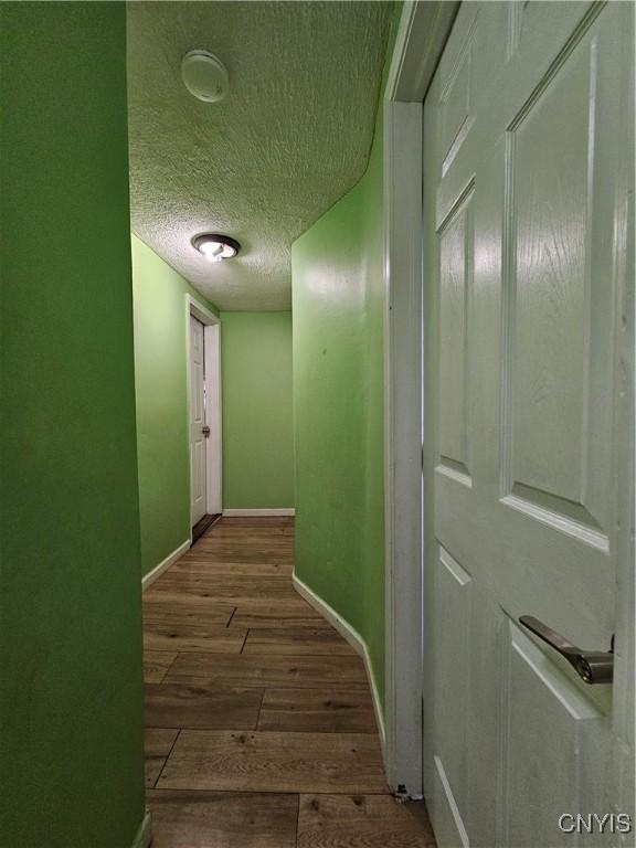 1125 Adams St, Utica, NY 13501 - hall with dark wood-type flooring and a textured ceiling