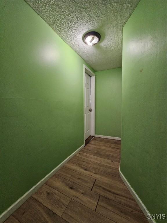 1125 Adams St, Utica, NY 13501 - corridor featuring wood finished floors and a textured ceiling