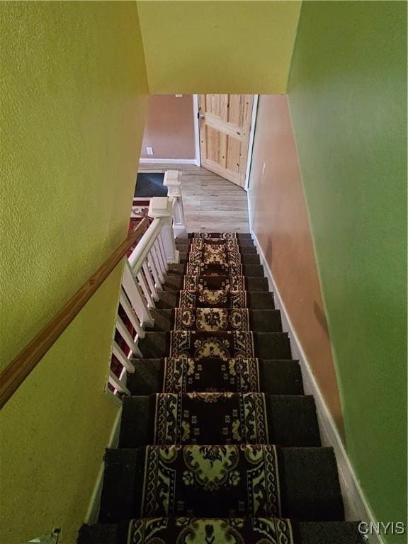 1125 Adams St, Utica, NY 13501 - stairs featuring baseboards and wood finished floors