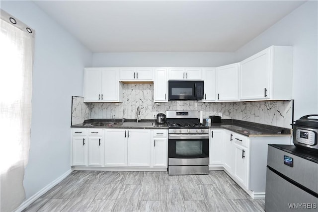 290 Riverside Ave, Buffalo, NY 14207 - kitchen featuring stainless steel gas range, black microwave, tasteful backsplash, and white cabinetry