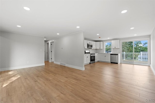 105 Benoit Dr, Geddes, NY 13209 - unfurnished living room featuring light wood finished floors and recessed lighting