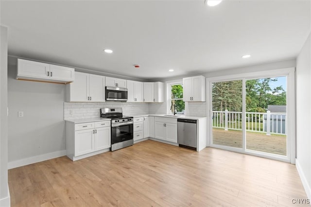 105 Benoit Dr, Geddes, NY 13209 - kitchen with appliances with stainless steel finishes, backsplash, light countertops, white cabinets, and recessed lighting