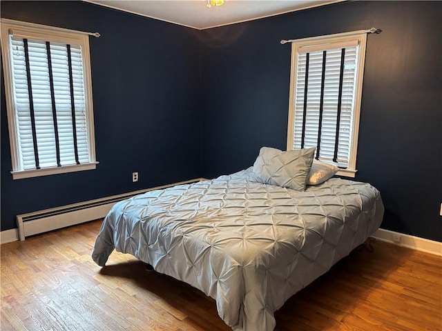 20-22 N Belmont Cir, Oneonta, NY 13820 - bedroom with wood finished floors and a baseboard heating unit