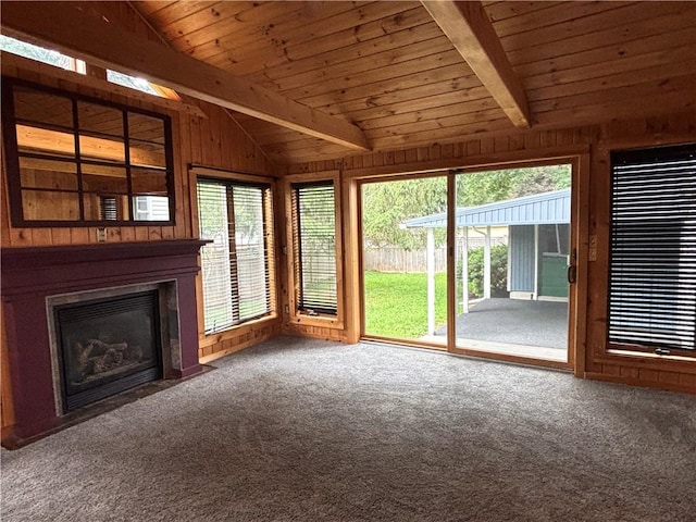 20-22 N Belmont Cir, Oneonta, NY 13820 - unfurnished living room featuring wooden walls, a fireplace with flush hearth, wood ceiling, and carpet