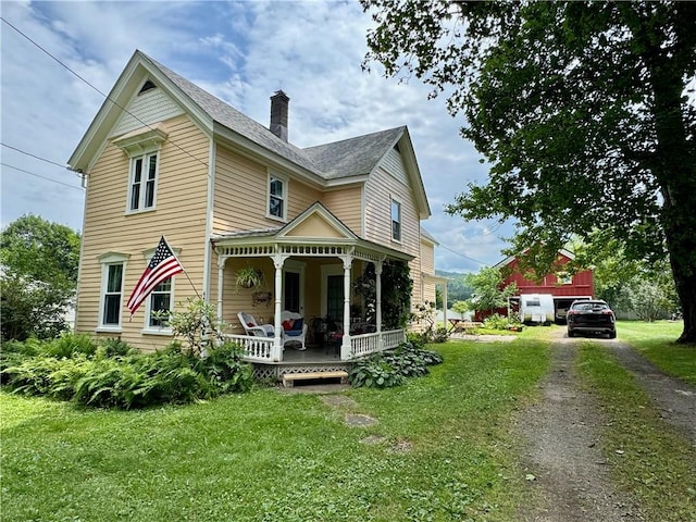44 Bloom St, Butternuts, NY 13776 - victorian-style house featuring covered porch, a front yard, a chimney, and driveway
