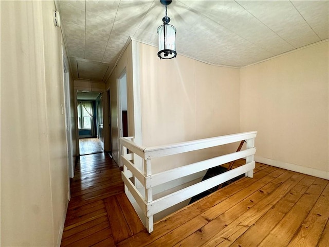 44 Bloom St, Butternuts, NY 13776 - corridor featuring an upstairs landing, attic access, hardwood / wood-style flooring, and ornamental molding
