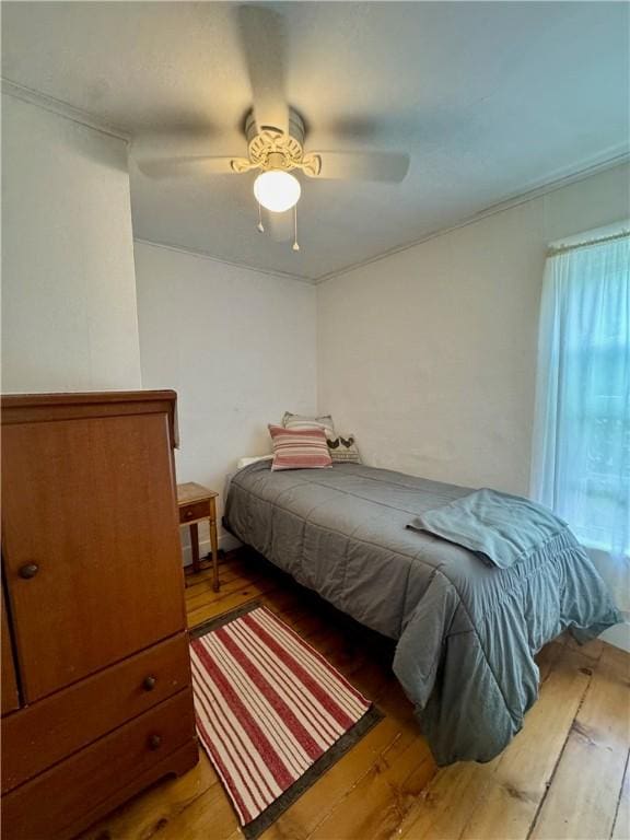 44 Bloom St, Butternuts, NY 13776 - bedroom featuring wood-type flooring, ceiling fan, and ornamental molding