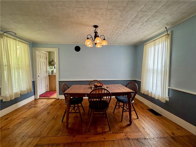 44 Bloom St, Butternuts, NY 13776 - dining space featuring hardwood / wood-style flooring and a chandelier