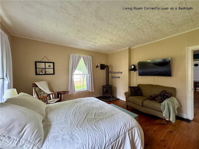 44 Bloom St, Butternuts, NY 13776 - bedroom with wood-type flooring, crown molding, and a wood stove
