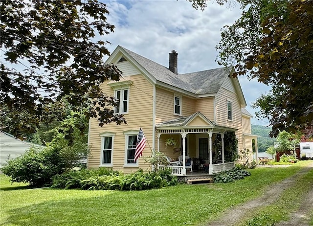 44 Bloom St, Butternuts, NY 13776 - victorian-style house featuring covered porch, a front lawn, a chimney, and driveway