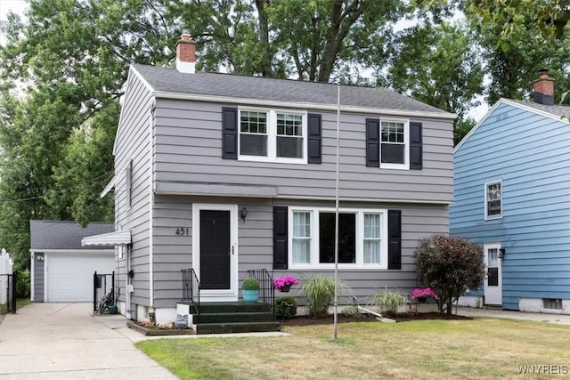 451 Moore Ave, Tonawanda, NY 14223 - colonial-style house featuring a front yard, a chimney, a detached garage, and an outbuilding