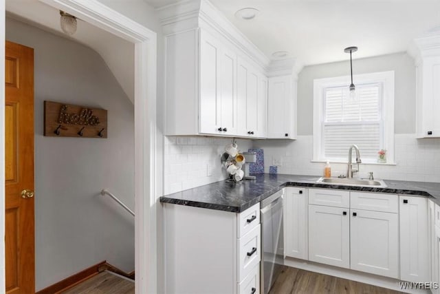 451 Moore Ave, Tonawanda, NY 14223 - kitchen with stainless steel dishwasher, light wood finished floors, white cabinetry, backsplash, and dark countertops