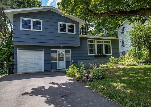 112 Haverhill Dr, Dewitt, NY 13214 - split level home with an attached garage, asphalt driveway, and a front yard