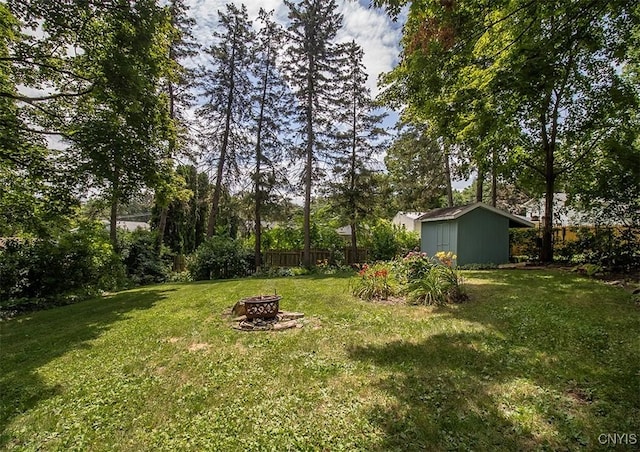 112 Haverhill Dr, Dewitt, NY 13214 - view of yard with a fire pit and a storage unit