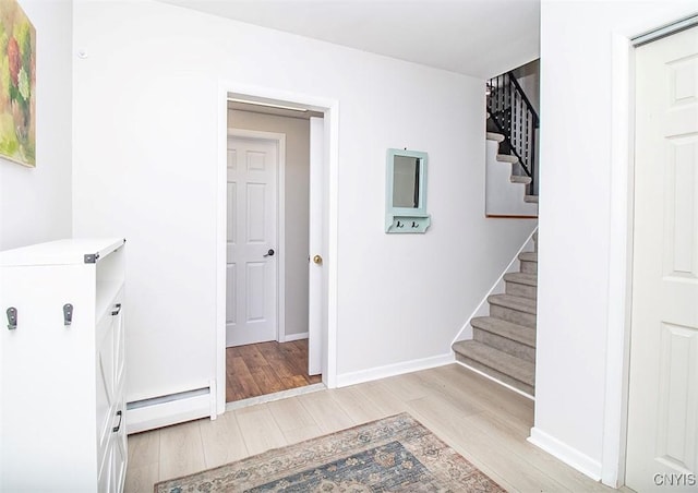 112 Haverhill Dr, Dewitt, NY 13214 - washroom featuring a baseboard radiator and light wood-style flooring