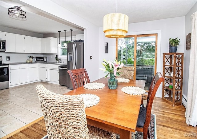 112 Haverhill Dr, Dewitt, NY 13214 - dining space with baseboard heating and light wood-style flooring