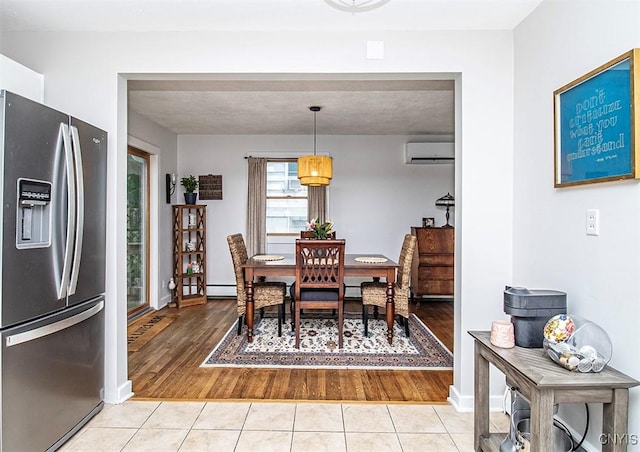 112 Haverhill Dr, Dewitt, NY 13214 - dining room with a wall unit AC, light tile patterned flooring, and a baseboard radiator