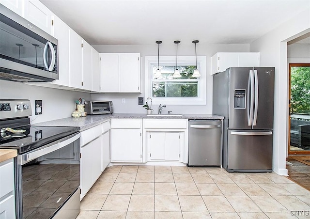 112 Haverhill Dr, Dewitt, NY 13214 - kitchen featuring stainless steel appliances, light countertops, white cabinets, and hanging light fixtures