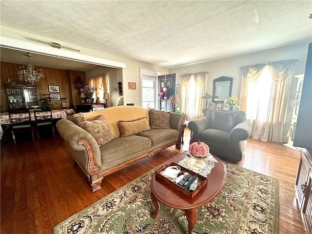 750 Reservoir St, Elmira City, NY 14905 - living room with a chandelier, wood finished floors, and a textured ceiling