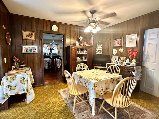 750 Reservoir St, Elmira City, NY 14905 - dining area featuring wood walls, a chandelier, and ceiling fan