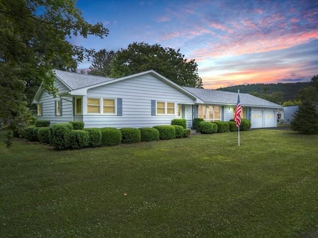 12 Sunset Dr, Afton, NY 13730 - ranch-style house with an attached garage, a front lawn, and roof with shingles