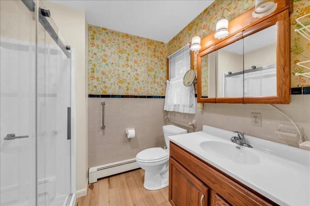 12 Sunset Dr, Afton, NY 13730 - bathroom with a baseboard radiator, wallpapered walls, wood finished floors, a shower stall, and vanity