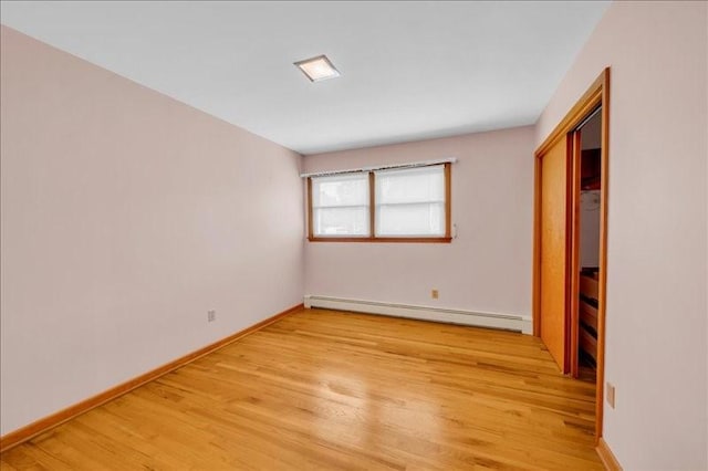 12 Sunset Dr, Afton, NY 13730 - unfurnished bedroom featuring a baseboard heating unit and light wood-style floors
