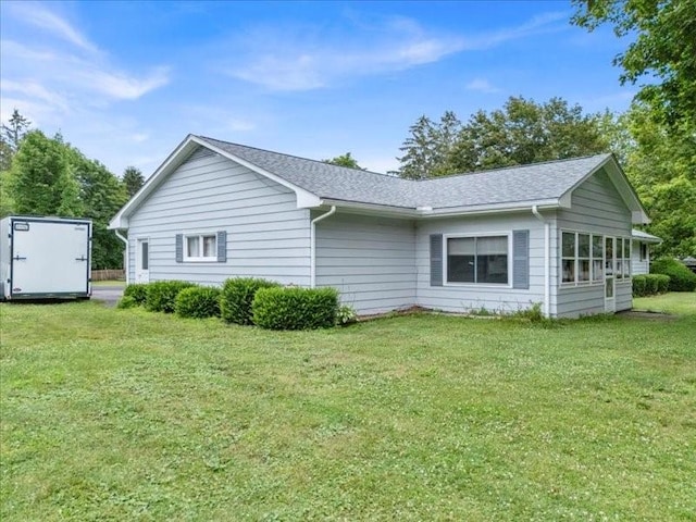 12 Sunset Dr, Afton, NY 13730 - view of property exterior featuring a storage shed, a yard, and roof with shingles