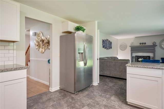 34 Stonewall Ct, Greece, NY 14615 - kitchen with stainless steel fridge with ice dispenser, a fireplace, white cabinets, backsplash, and open floor plan