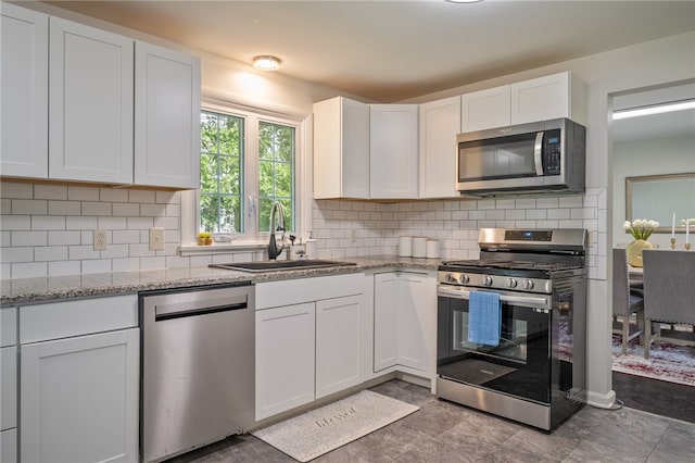 34 Stonewall Ct, Greece, NY 14615 - kitchen with stainless steel appliances, white cabinets, light stone counters, and backsplash