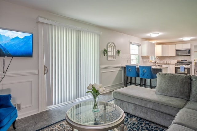 34 Stonewall Ct, Greece, NY 14615 - living area featuring a decorative wall and wainscoting