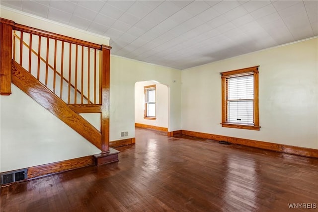 2239 Willow Ave, Niagara Falls, NY 14305 - unfurnished living room featuring arched walkways, plenty of natural light, wood finished floors, ornamental molding, and stairs
