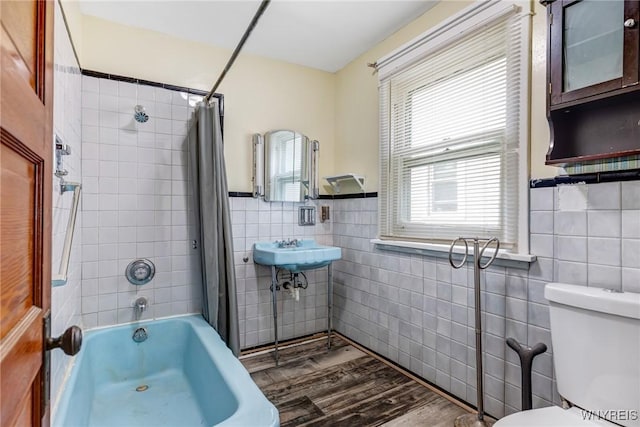 2239 Willow Ave, Niagara Falls, NY 14305 - bathroom featuring tile walls, shower / tub combo with curtain, wood finished floors, and wainscoting