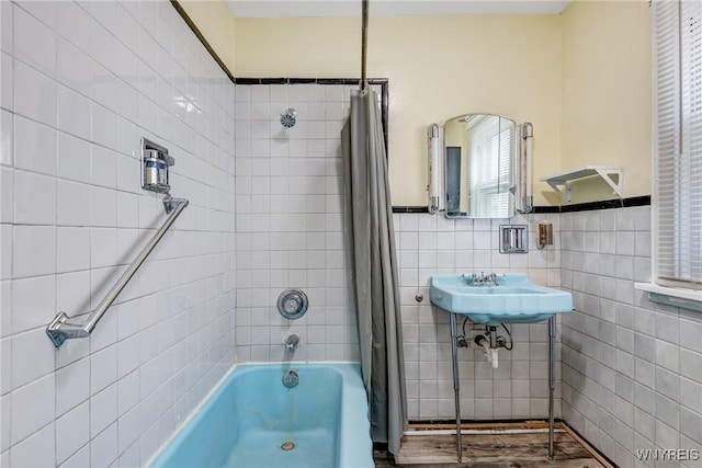 2239 Willow Ave, Niagara Falls, NY 14305 - bathroom with tile walls, shower / bath combo, and wainscoting