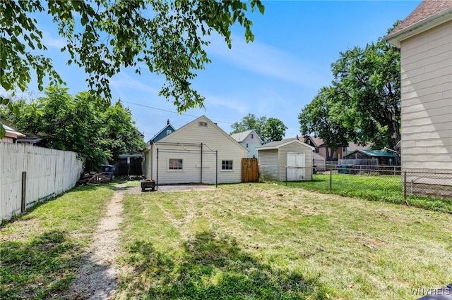 2239 Willow Ave, Niagara Falls, NY 14305 - back of house with a fenced backyard and a storage unit