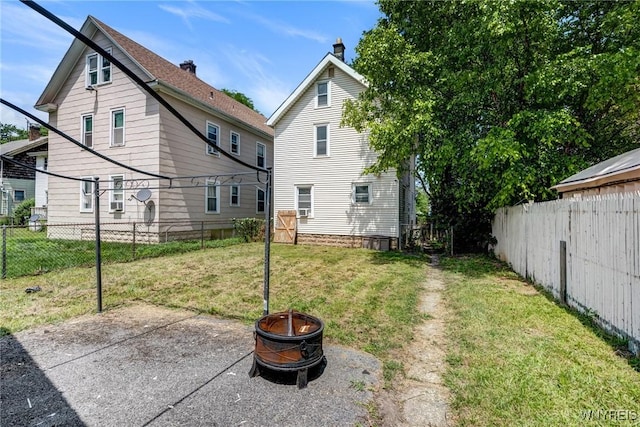 2239 Willow Ave, Niagara Falls, NY 14305 - rear view of house featuring an outdoor fire pit, a fenced backyard, and a patio area