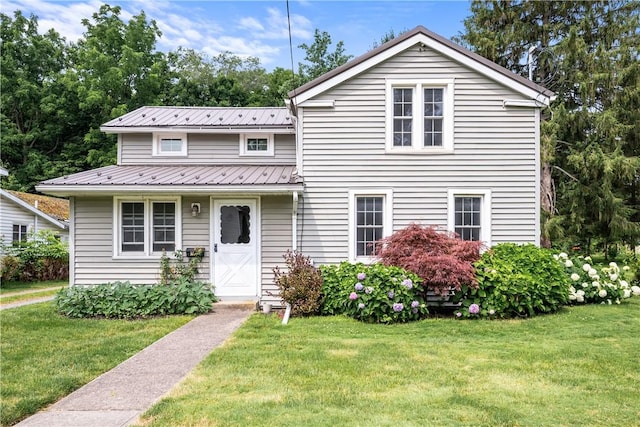 11 Walnut St, Phelps, NY 14533 - view of front facade featuring a front lawn and a metal roof
