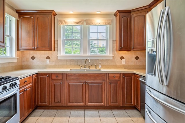 11 Walnut St, Phelps, NY 14533 - kitchen featuring stainless steel appliances, light countertops, light tile patterned flooring, and brown cabinets