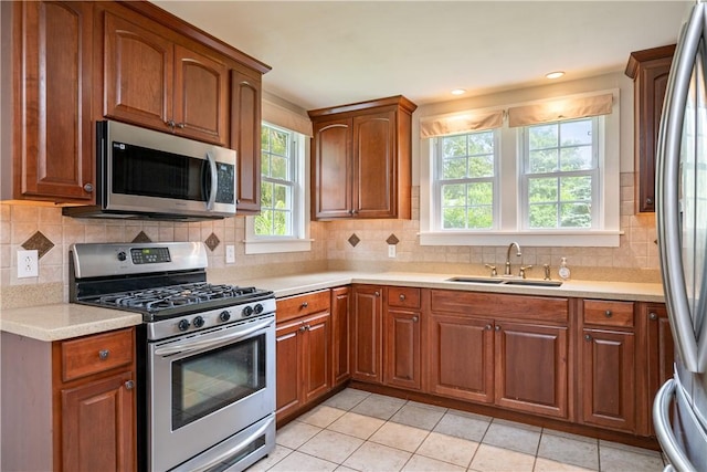 11 Walnut St, Phelps, NY 14533 - kitchen with stainless steel appliances, light countertops, tasteful backsplash, and brown cabinets