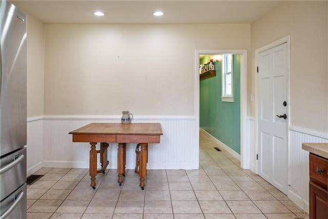 11 Walnut St, Phelps, NY 14533 - dining area with a wainscoted wall, light tile patterned floors, and recessed lighting