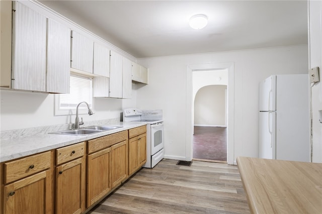 900-902 S Plymouth Ave, Rochester, NY 14608 - kitchen with white appliances, light countertops, light wood-style flooring, crown molding, and brown cabinetry