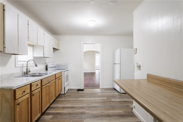 900-902 S Plymouth Ave, Rochester, NY 14608 - kitchen featuring white appliances, arched walkways, light wood-style floors, light countertops, and brown cabinets