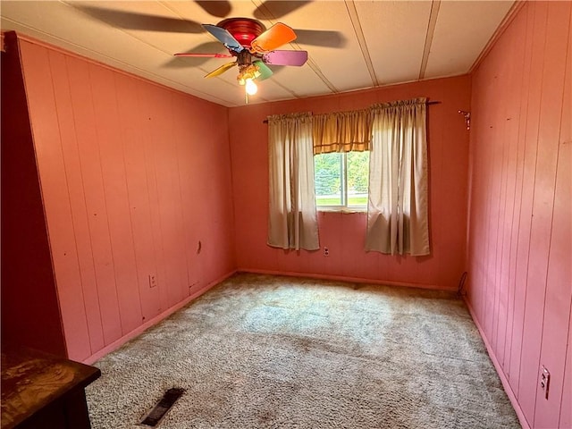 1796 Gladstone Hollow Rd, Andes, NY 13731 - spare room with light colored carpet, wood walls, and a ceiling fan