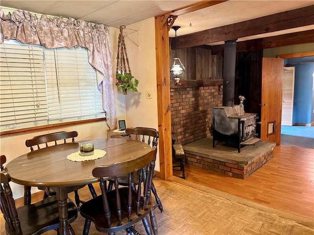 1796 Gladstone Hollow Rd, Andes, NY 13731 - dining area featuring a wood stove, light wood-type flooring, and beamed ceiling