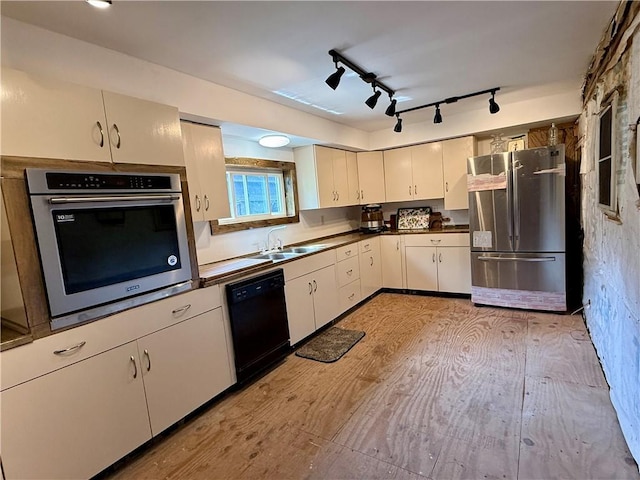 1796 Gladstone Hollow Rd, Andes, NY 13731 - kitchen featuring appliances with stainless steel finishes, light wood-type flooring, dark countertops, white cabinets, and track lighting